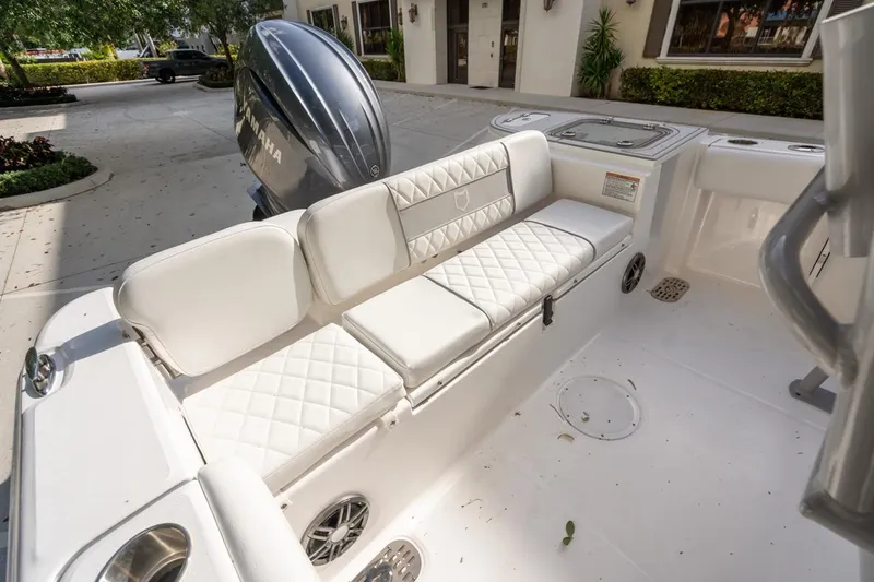 Slide: The Image of 2025 Sea Fox 228 Commander boat interior with white cushioned seating and Yamaha engine. - 10