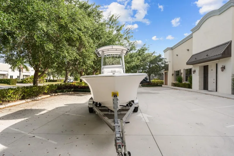 Slide: The Image of 2025 Sea Fox 228 Commander boat on trailer in sunny parking lot. - 3