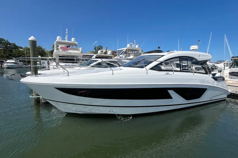 Slide: The Image of 2026 Beneteau Gran Turismo 41 yacht docked in marina under clear blue sky. - 11