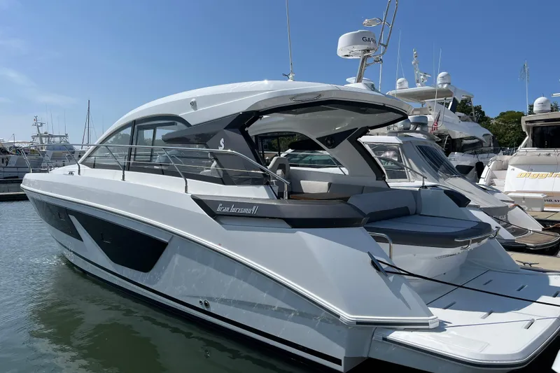 Slide: The Image of 2026 Beneteau Gran Turismo 41 yacht docked at marina under clear blue sky. - 13