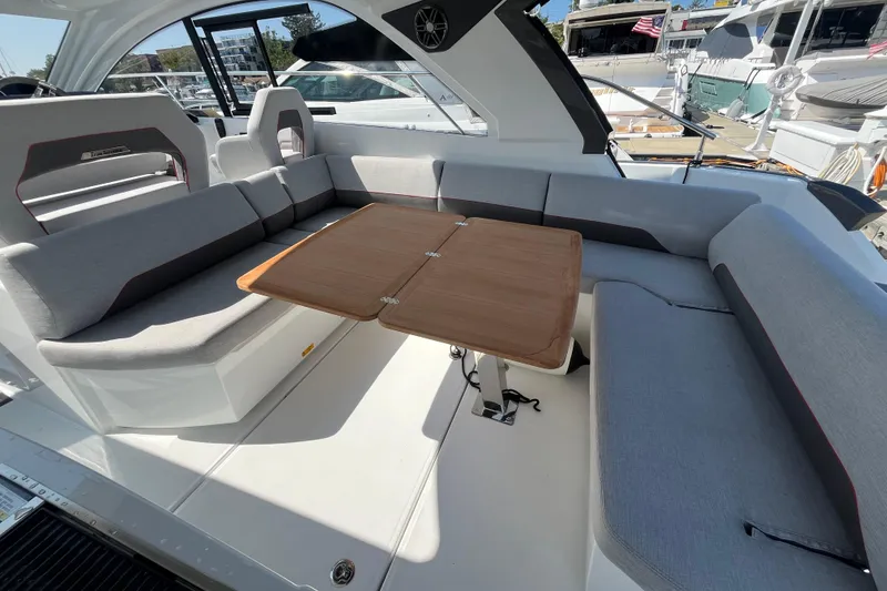 Slide: The Image of Luxurious seating area on 2026 Beneteau Gran Turismo 41 yacht with wooden table. - 23
