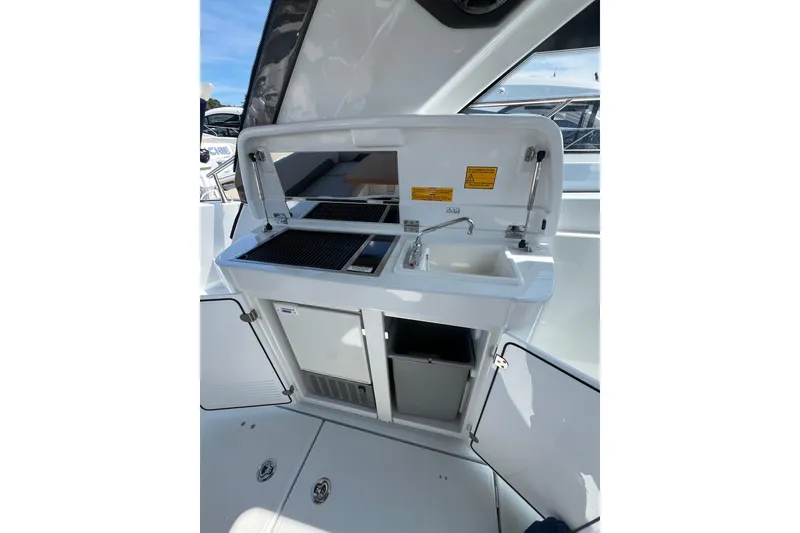 Slide: The Image of 2026 Beneteau Gran Turismo 41 yacht kitchenette with sink and grill. - 24