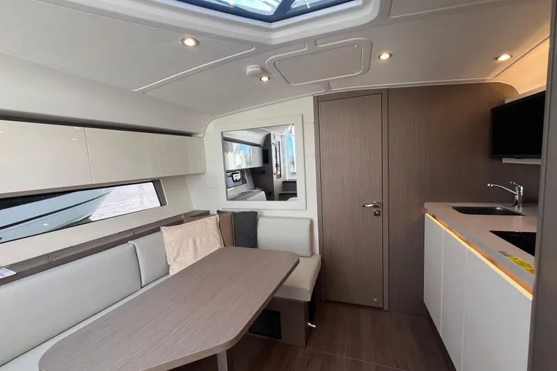 Slide: The Image of Luxurious interior of 2026 Beneteau Gran Turismo 41 yacht with modern kitchen and seating area. - 30