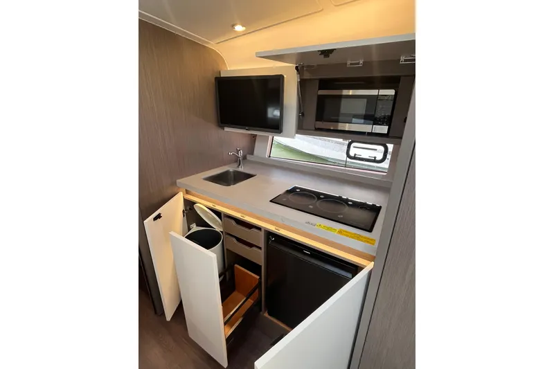 Slide: The Image of Modern kitchen in 2026 Beneteau Gran Turismo 41 yacht with appliances and storage. - 35