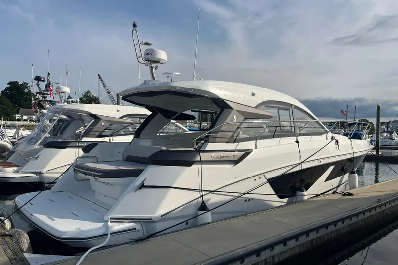 Slide: The Image of 2026 Beneteau Gran Turismo 41 yacht docked at marina under cloudy sky. - 9