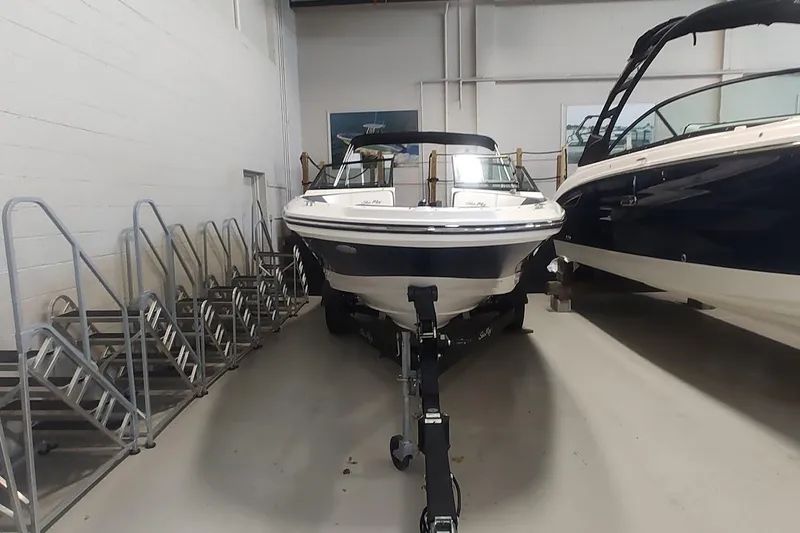 Slide: The Image of 2018 Sea Ray SPX 190 boat on trailer in indoor storage facility. - 0