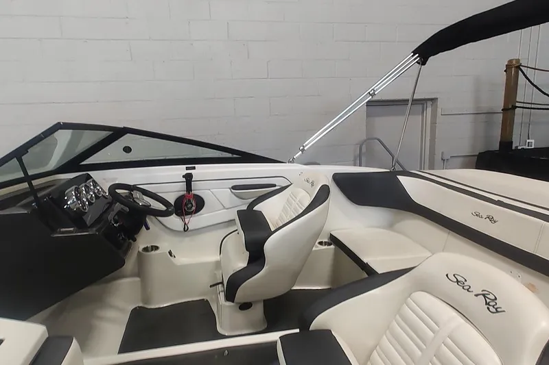 Slide: The Image of 2018 Sea Ray SPX 190 boat interior with steering wheel and seating. - 5