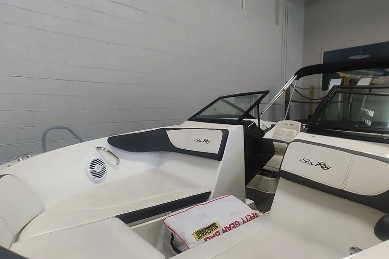 Slide: The Image of 2018 Sea Ray SPX 190 boat interior with white seating and black accents. - 6
