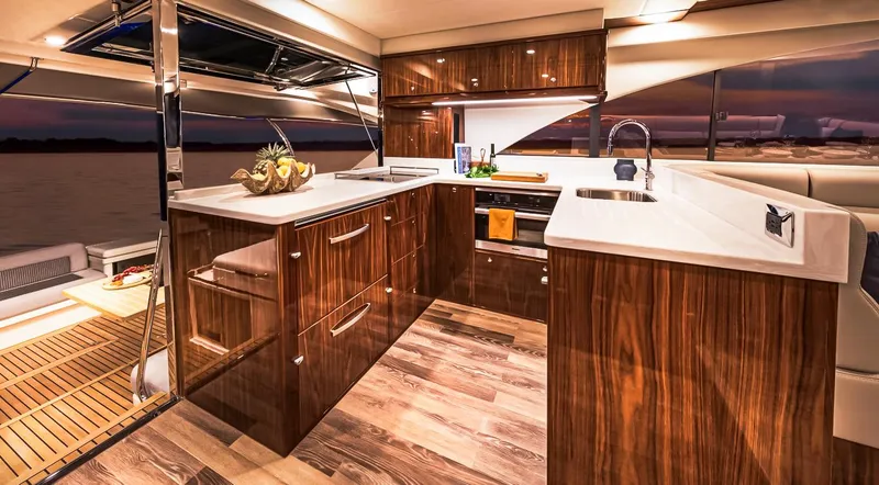 Slide: The Image of Luxurious kitchen interior of 2023 Riviera 57 Enclosed Flybridge yacht at sunset. - 7