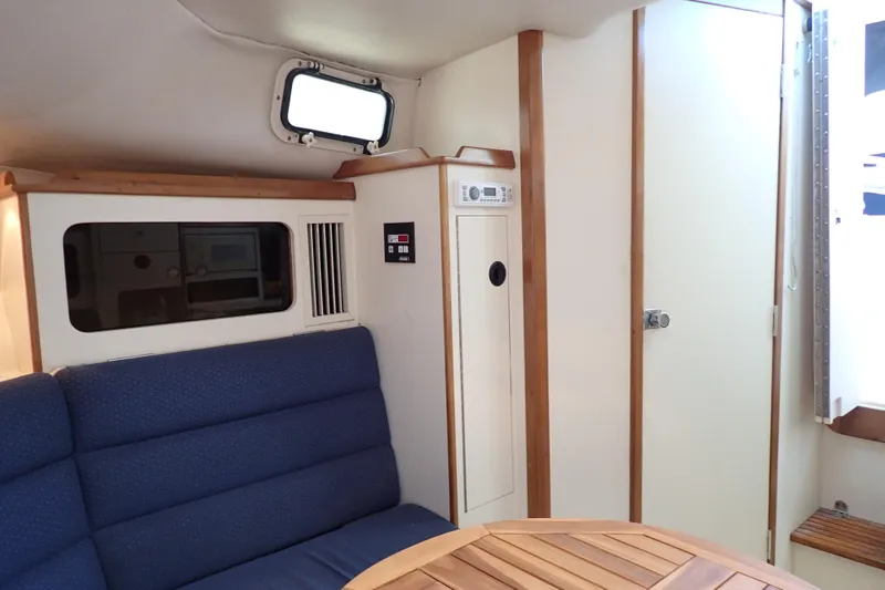 Slide: The Image of Interior of 2000 Albin 28 Tournament Express with blue seating and wooden accents. - 14