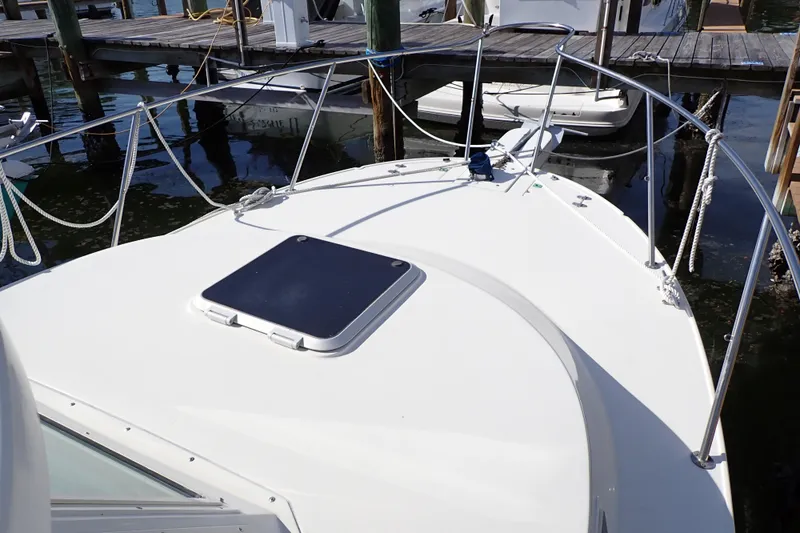 Slide: The Image of 2000 Albin 28 Tournament Express boat deck with railing and hatch, docked at marina. - 17