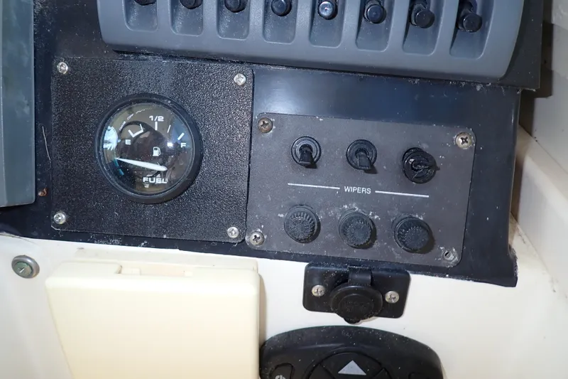 Slide: The Image of Control panel of a 2000 Albin 28 Tournament Express with fuel gauge and wiper switches. - 29