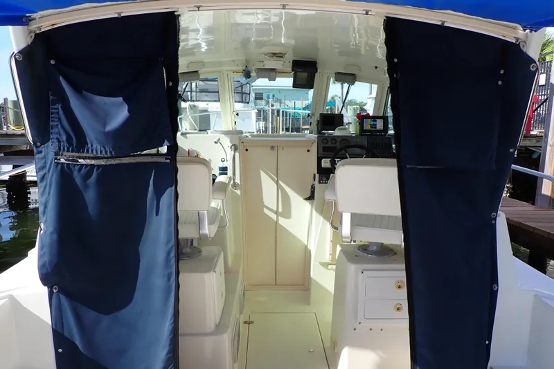 Slide: The Image of Interior view of 2000 Albin 28 Tournament Express boat with blue curtains. - 3