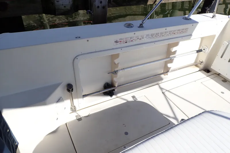 Slide: The Image of 2000 Albin 28 Tournament Express boat deck with storage compartment and railing. - 35