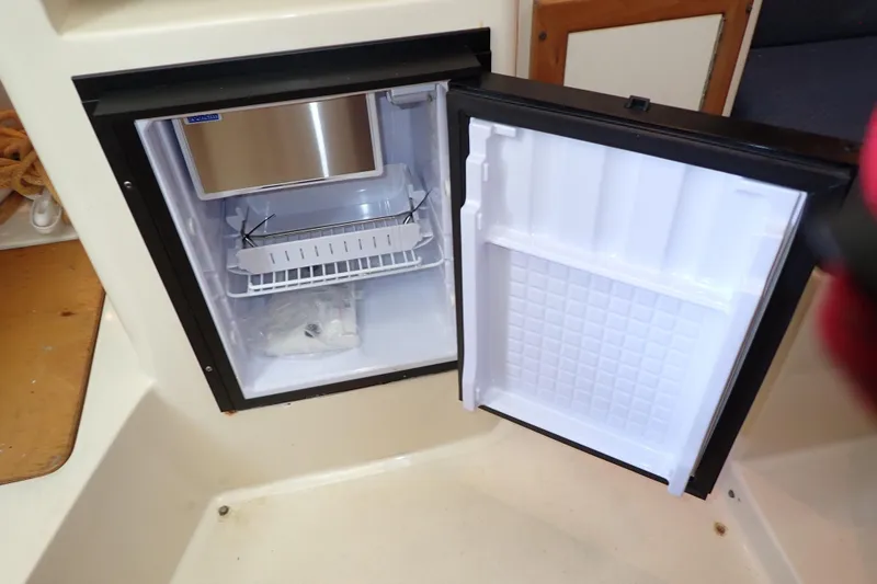 Slide: The Image of Open mini fridge inside 2000 Albin 28 Tournament Express boat cabin. - 40