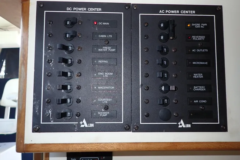 Slide: The Image of Electrical panel of a 2000 Albin 28 Tournament Express boat, showing DC and AC power controls. - 42