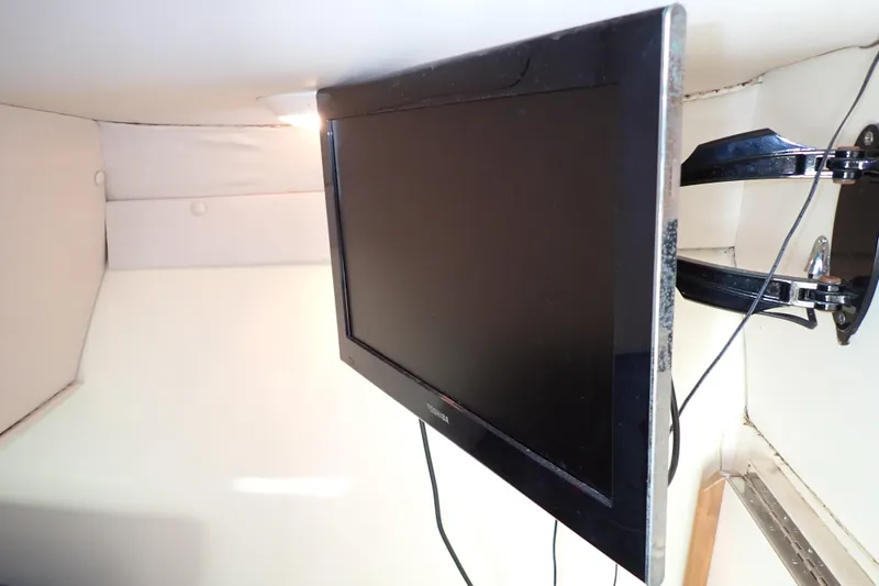 Slide: The Image of Flat-screen TV mounted inside 2000 Albin 28 Tournament Express boat cabin. - 44