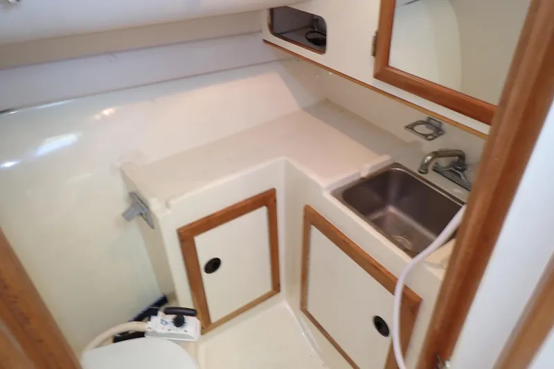 Slide: The Image of 2000 Albin 28 Tournament Express boat interior with sink and storage cabinets. - 51
