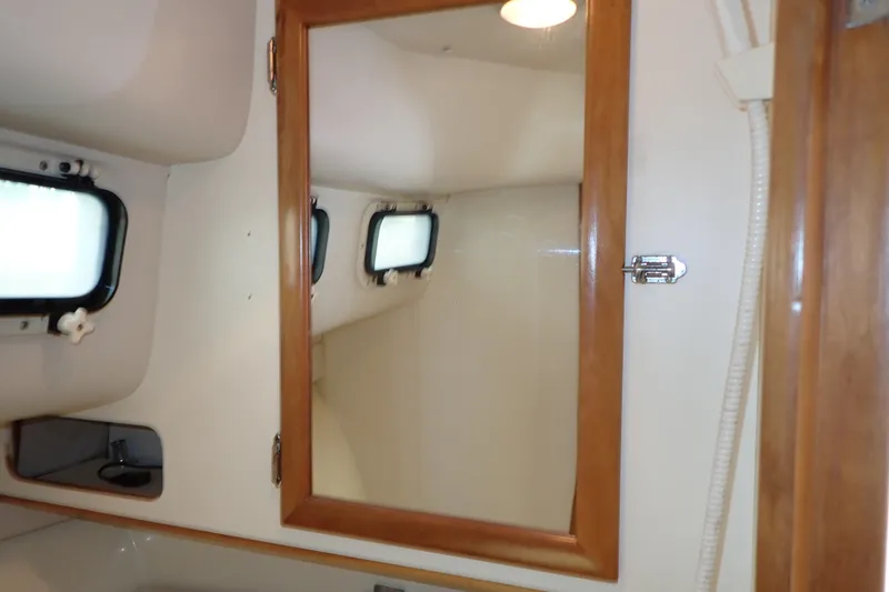 Slide: The Image of Interior of 2000 Albin 28 Tournament Express boat with wooden framed mirror and windows. - 55