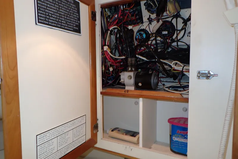 Slide: The Image of Electrical panel inside a 2000 Albin 28 Tournament Express boat, showcasing wiring and components. - 56