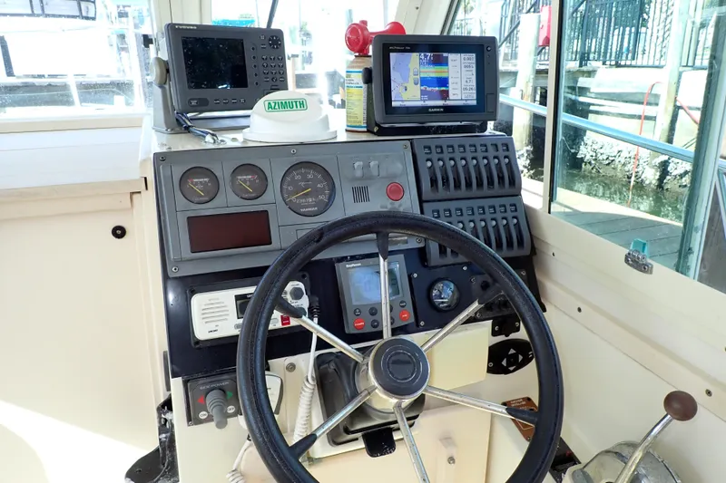 Slide: The Image of Helm of 2000 Albin 28 Tournament Express with navigation equipment and controls. - 7