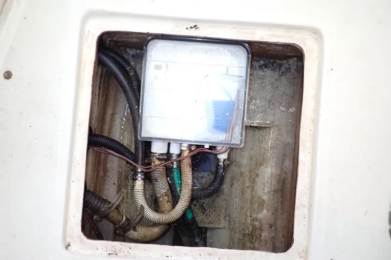 Slide: The Image of Bilge compartment of 2000 Albin 28 Tournament Express with visible wiring and hoses. - 73