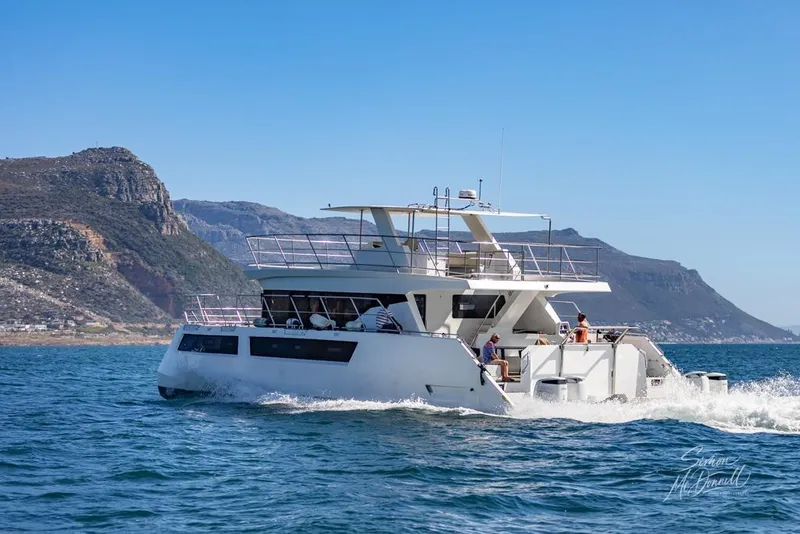 Slide: The Image of 2024 Leeuwin 55 yacht cruising near scenic coastal cliffs. - 0