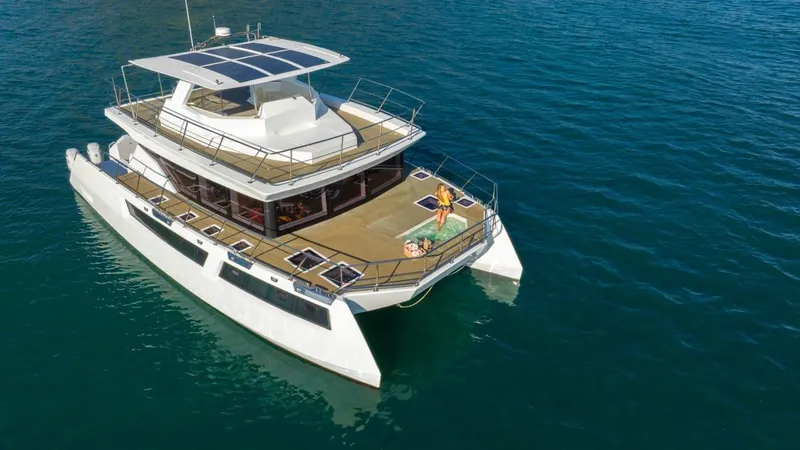 Slide: The Image of 2024 Leeuwin 55 yacht cruising on open water, featuring spacious deck and modern design. - 1