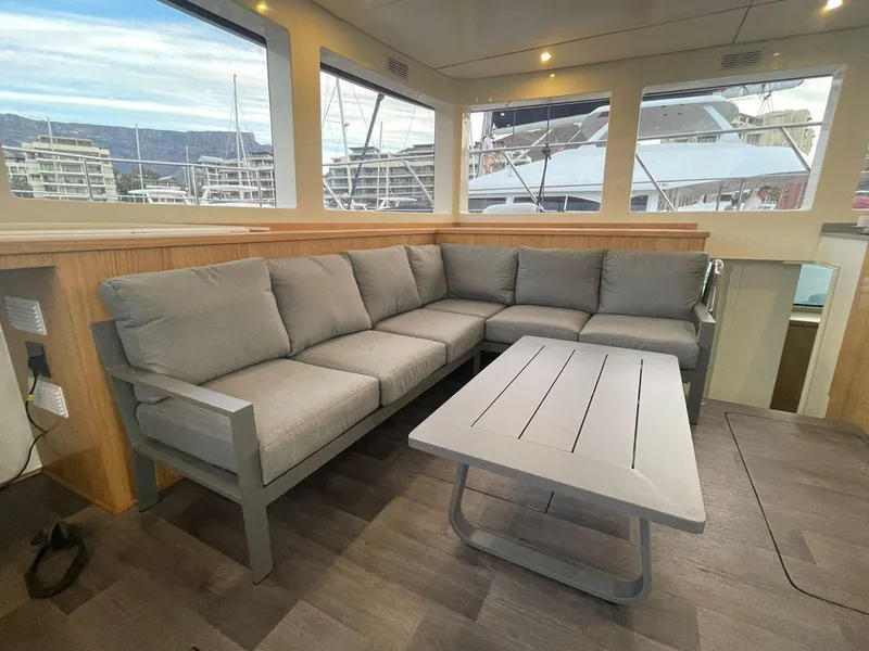 Slide: The Image of Modern interior of 2024 Leeuwin 55 yacht with gray sofa and table. - 13