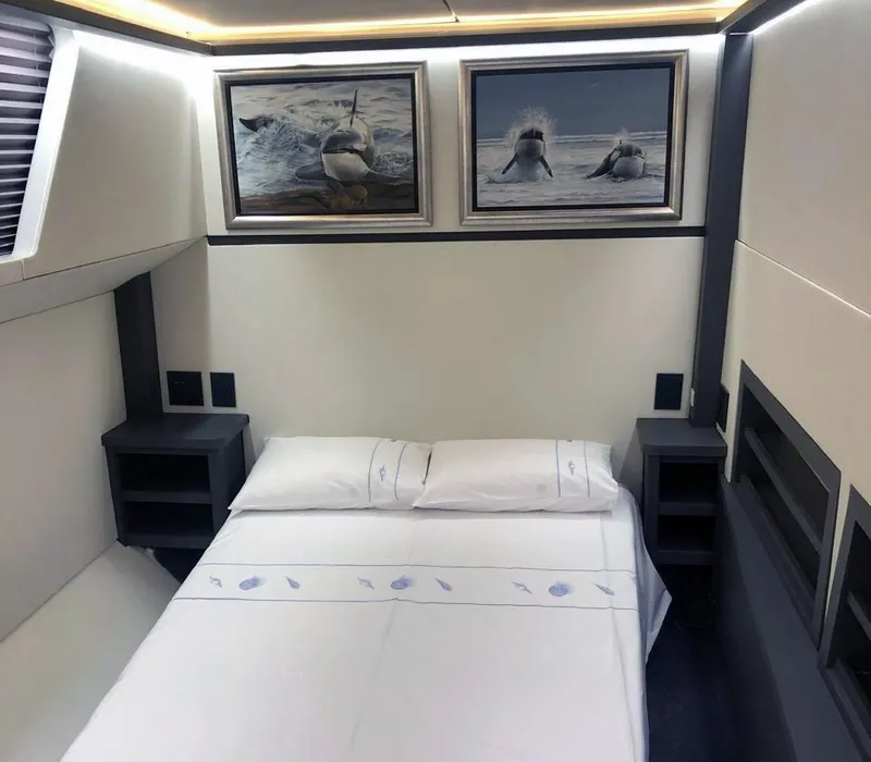 Slide: The Image of Luxurious 2024 Leeuwin 55 yacht bedroom with elegant decor and marine-themed artwork. - 15