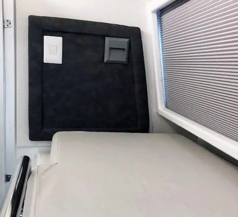 Slide: The Image of 2024 Leeuwin 55 interior with bed and window blinds. - 16