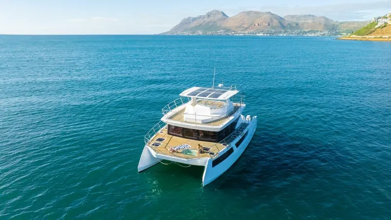 Slide: The Image of Luxurious 2024 Leeuwin 55 yacht cruising in clear blue waters with scenic mountain backdrop. - 18