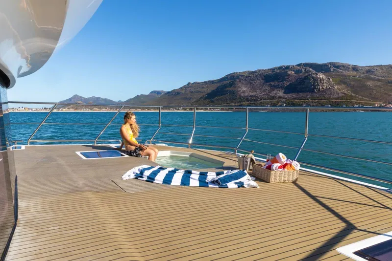 Slide: The Image of Luxury yacht deck with jacuzzi, woman relaxing, ocean view, Leeuwin 55, 2024 model. - 20