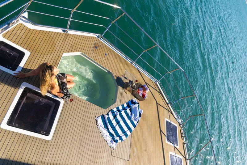 Slide: The Image of Woman relaxing in jacuzzi on 2024 Leeuwin 55 yacht deck, overlooking ocean. - 21