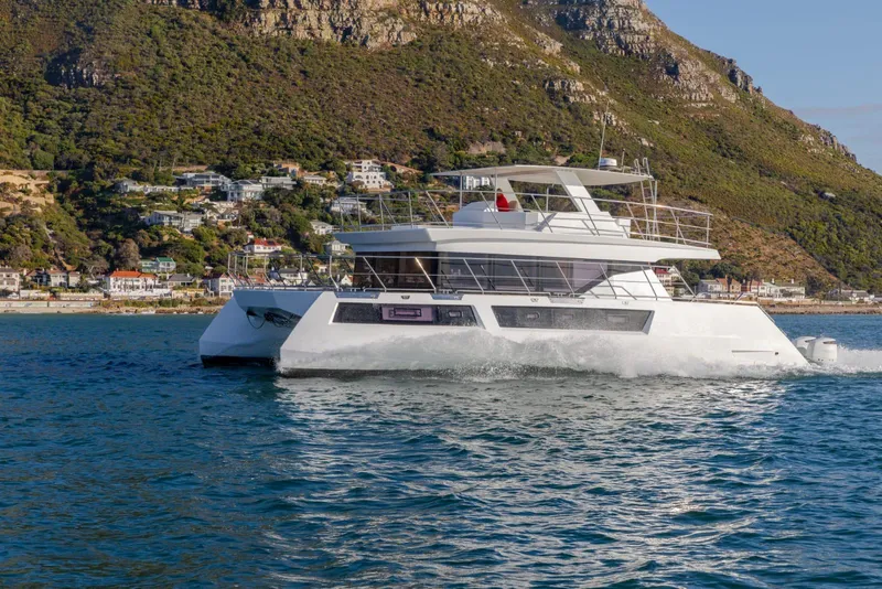 Slide: The Image of 2024 Leeuwin 55 yacht cruising near scenic coastal landscape. - 28