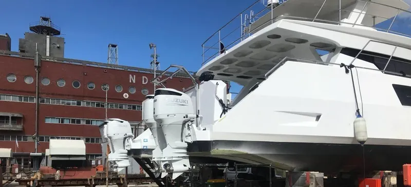 Slide: The Image of 2024 Leeuwin 55 yacht with Suzuki engines docked near industrial building. - 31