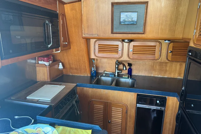 Slide: The Image of Galley kitchen in 1995 Nordhavn 46 yacht with wood cabinetry and modern appliances. - 14