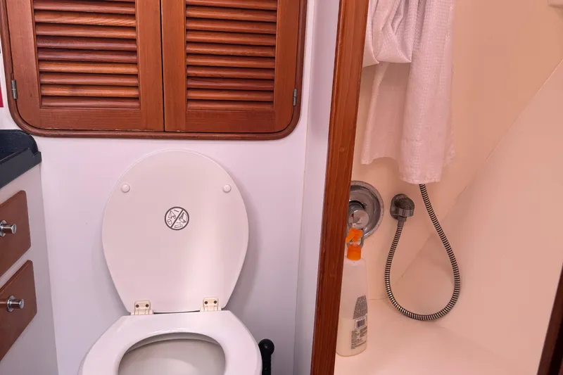Slide: The Image of Bathroom interior of a 1995 Nordhavn 46 yacht, featuring a toilet and shower area. - 19