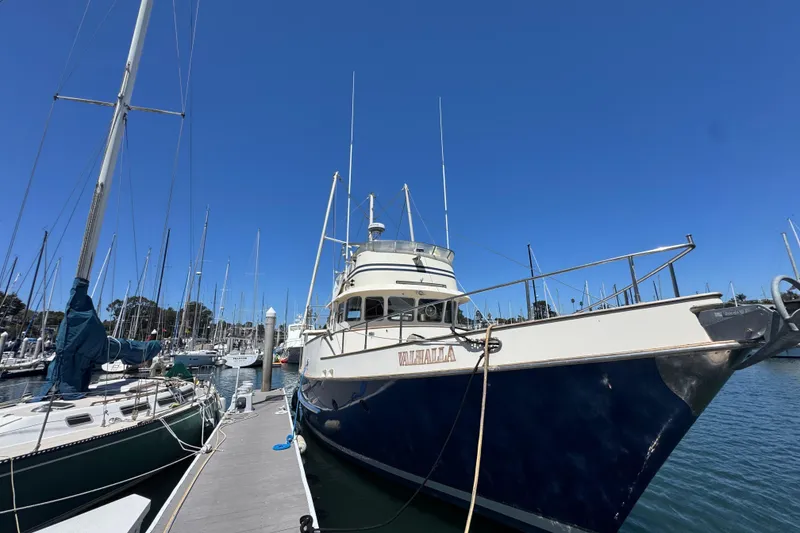 Slide: The Image of 1995 Nordhavn 46 yacht docked at marina under clear blue sky. - 2