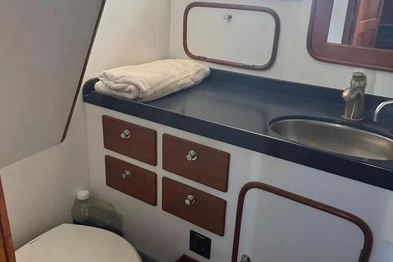 Slide: The Image of Bathroom interior of 1995 Nordhavn 46 yacht with sink, counter, and storage. - 25