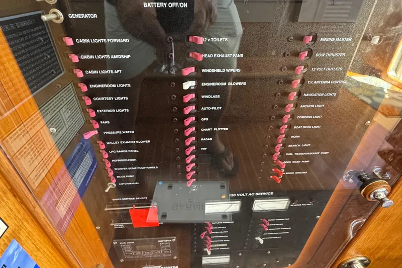 Slide: The Image of Control panel of a 1995 Nordhavn 46 yacht, featuring various switches and indicators. - 26
