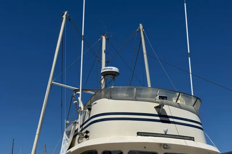 Slide: The Image of 1995 Nordhavn 46 boat mast and radar against clear blue sky. - 3