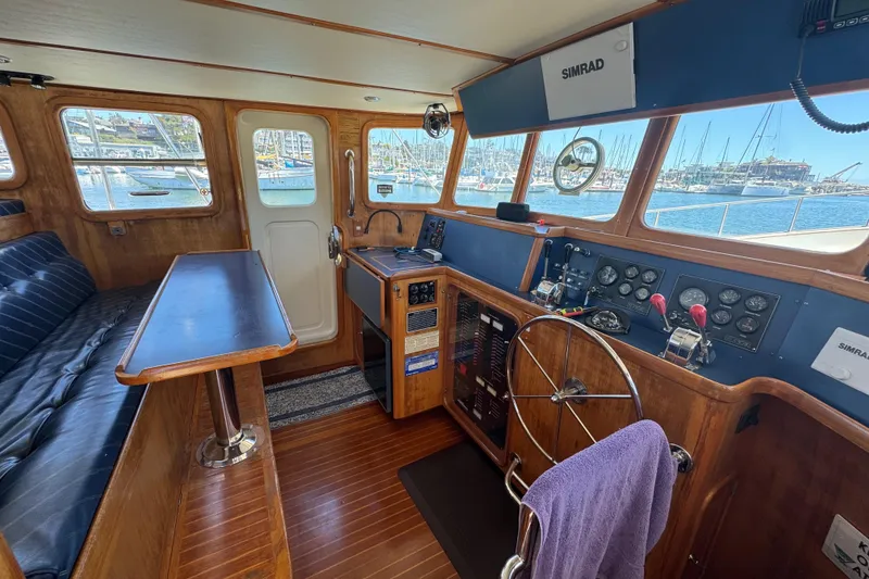 Slide: The Image of Interior of a 1995 Nordhavn 46 yacht with wooden helm and navigation equipment. - 30