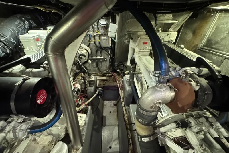 Slide: The Image of Engine room of a 1995 Nordhavn 46 yacht, showcasing mechanical components and piping. - 31