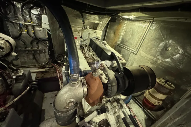 Slide: The Image of Engine room of a 1995 Nordhavn 46 yacht, showcasing mechanical components and piping. - 32