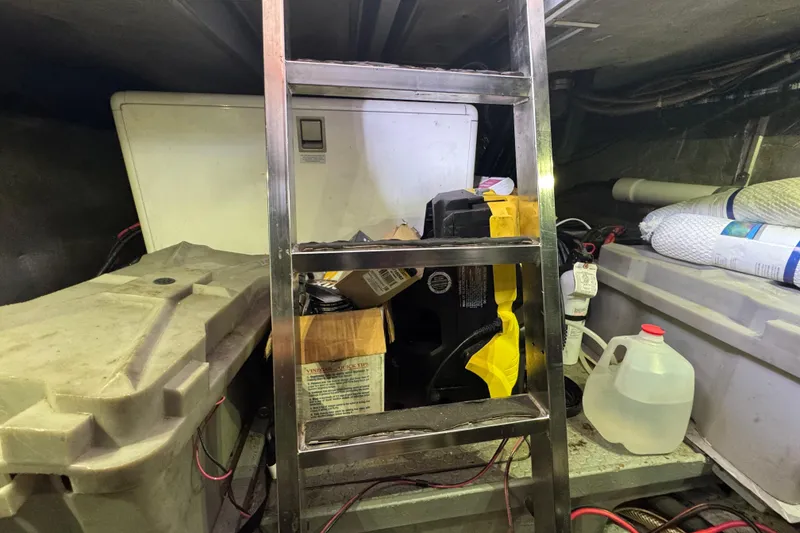 Slide: The Image of Engine room of 1995 Nordhavn 46 with storage items and ladder. - 33