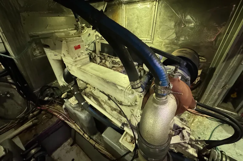 Slide: The Image of Engine room of a 1995 Nordhavn 46 yacht, showcasing mechanical components and wiring. - 36