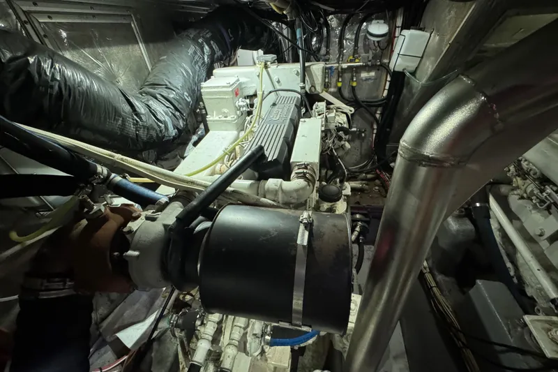 Slide: The Image of Engine room of a 1995 Nordhavn 46 yacht, showcasing mechanical components and piping. - 37