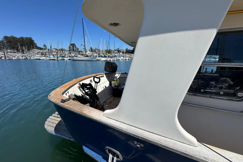 Slide: The Image of Nordhavn 46 yacht docked at marina, showcasing stern and deck details. - 4