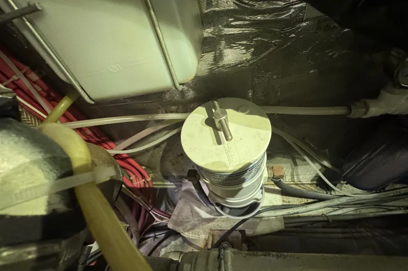 Slide: The Image of Engine compartment of a 1995 Nordhavn 46 boat, featuring wiring and a filter system. - 40